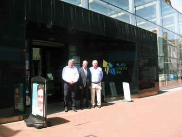 Altaf Hussain, centre, poses outside the Gwyn Hall with Mr Collins, left and Coun Peters, right.